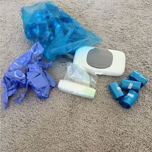 Bundle of oxo travel wipes dispenser and several disposable diaper bags